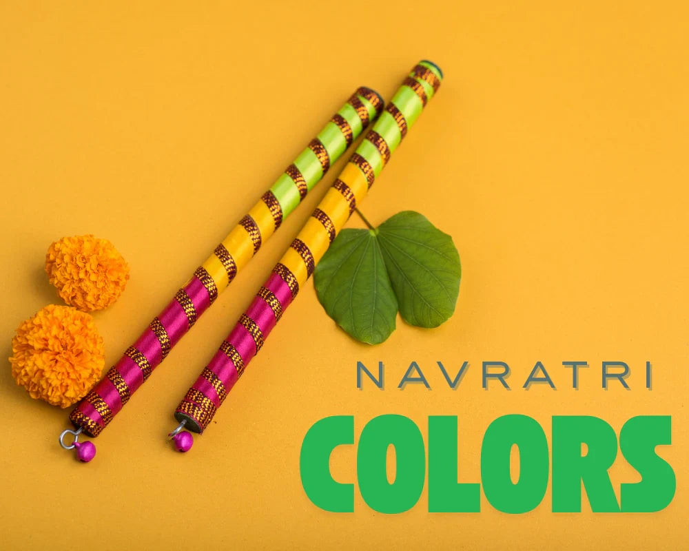 Decorative dandiya sticks with marigold flowers and a leaf on a yellow background with 'Navratri Colors' text.