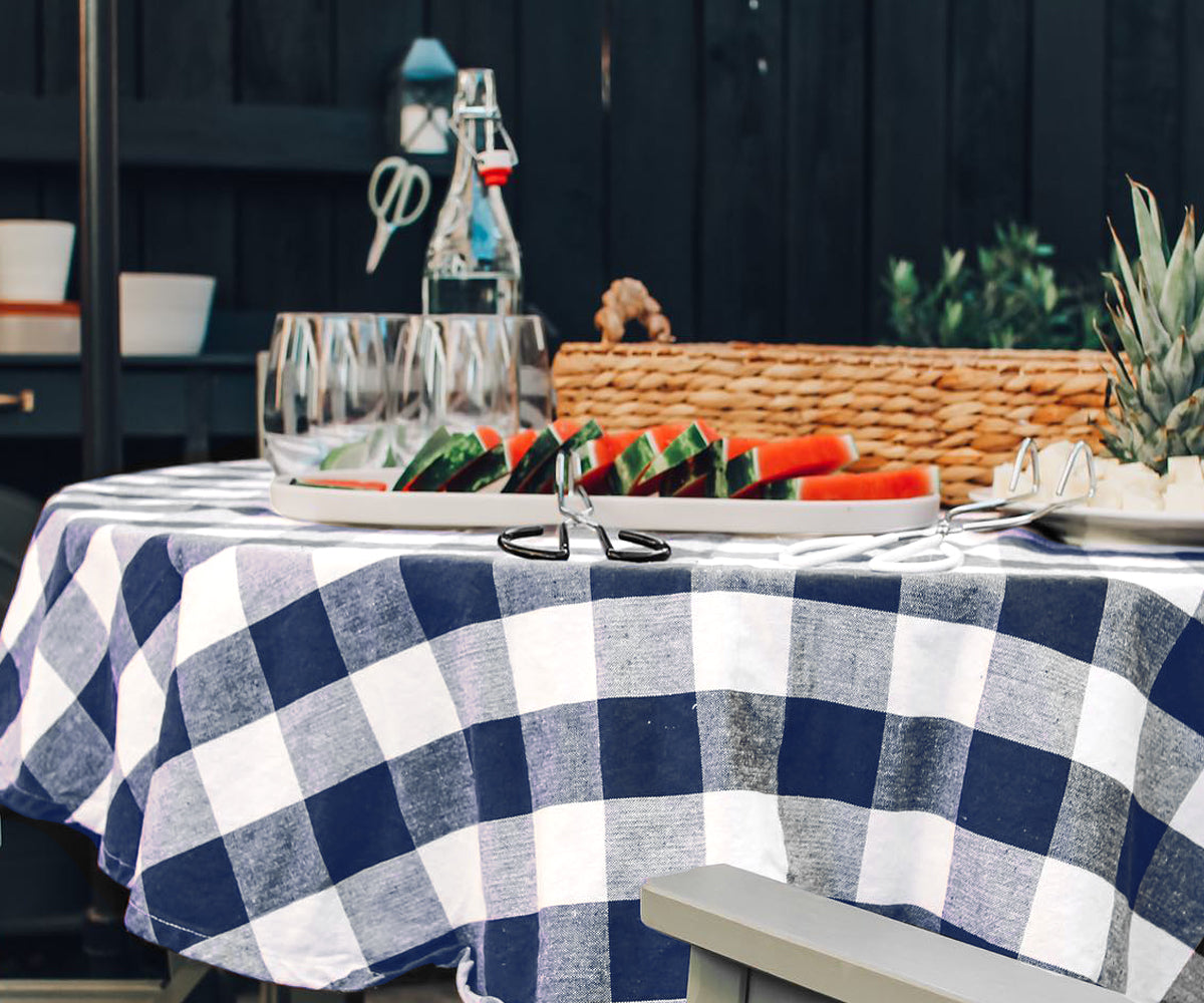Farmhouse-style dining area with a striped cotton tablecloth, mason jar centerpieces, and vintage dishware