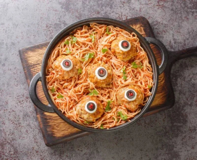 Spooky spaghetti with meatball eyeballs prepared as a Halloween dinner.