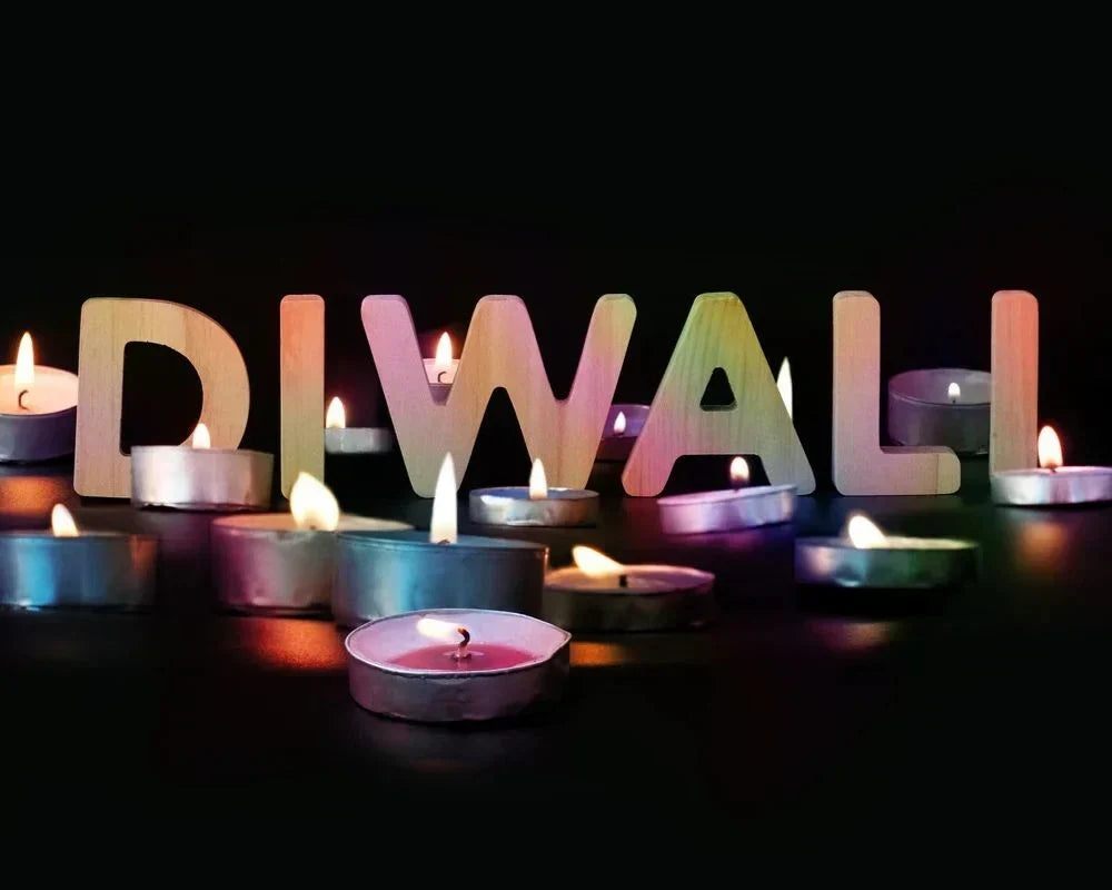 Modern "DIWALL" light-up letters and glowing diyas for contemporary Diwali home decor.