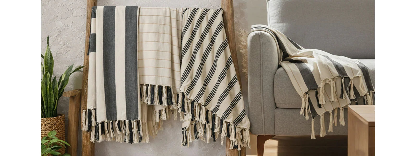 Natural cotton striped throw blanket layered on a sofa – breathable cotton home throw for living room decor