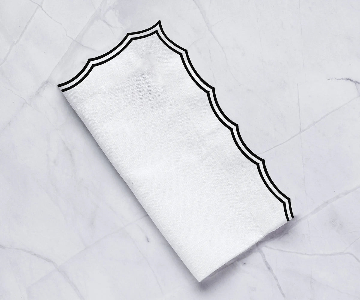 Elegant embroidered dinner napkins on a formal dining table