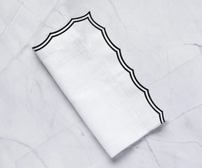 Elegant embroidered dinner napkins on a formal dining table