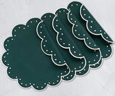 Elegant round cotton placemat with scalloped edges and fine dotted embroidery, ideal for enhancing formal or casual dining tables.