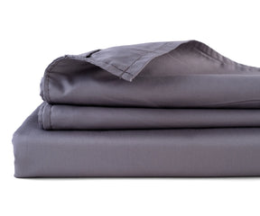   grey cotton sateen flat sheet neatly spread on a bed

