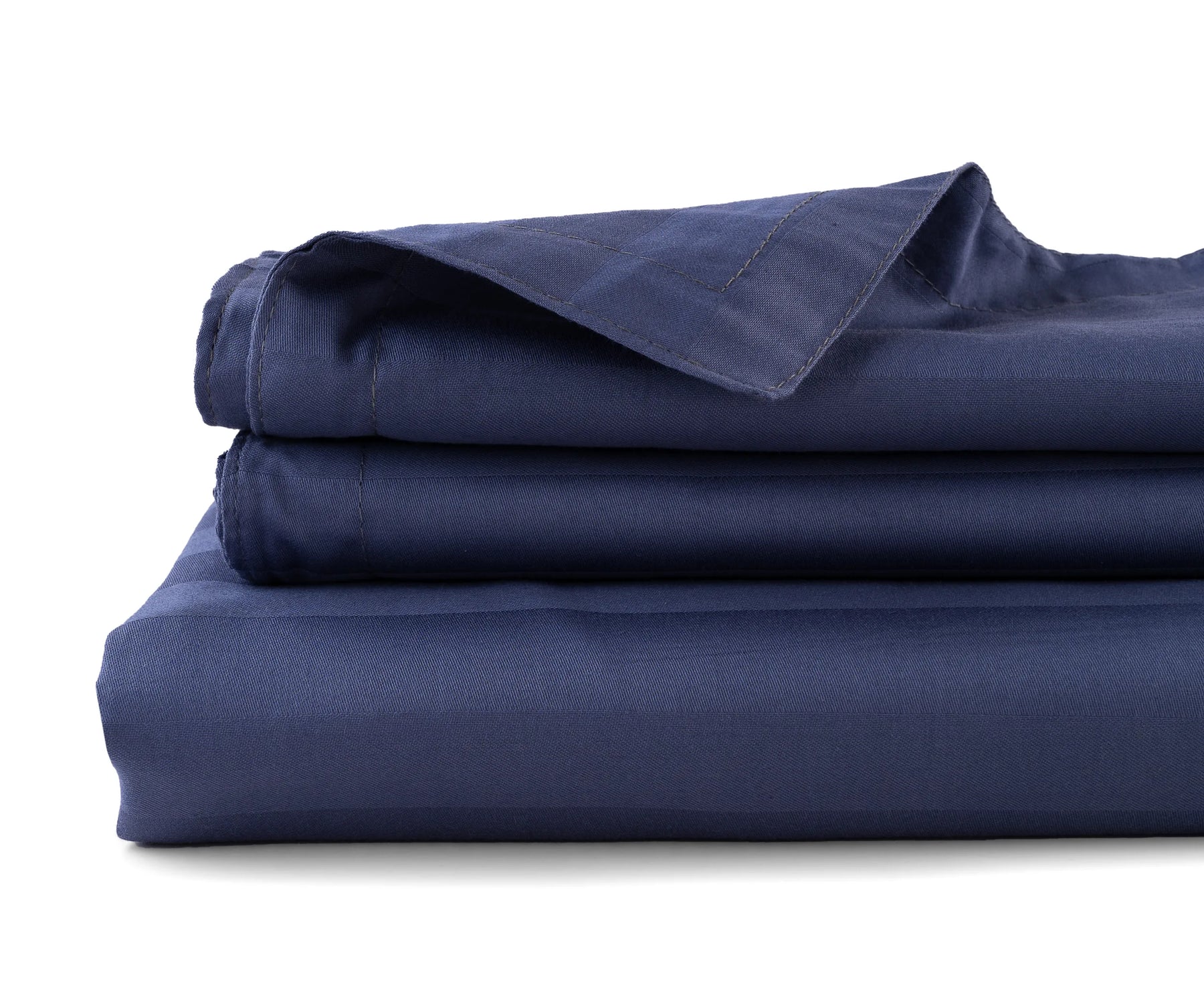 Striped cotton sateen flat sheet neatly spread on a bed in elegant pattern
