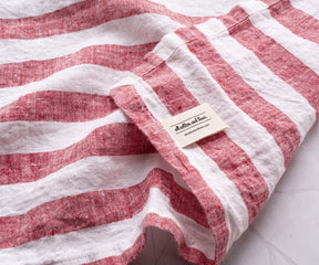 Italian Stripe Napkin in red and white, displayed on a table