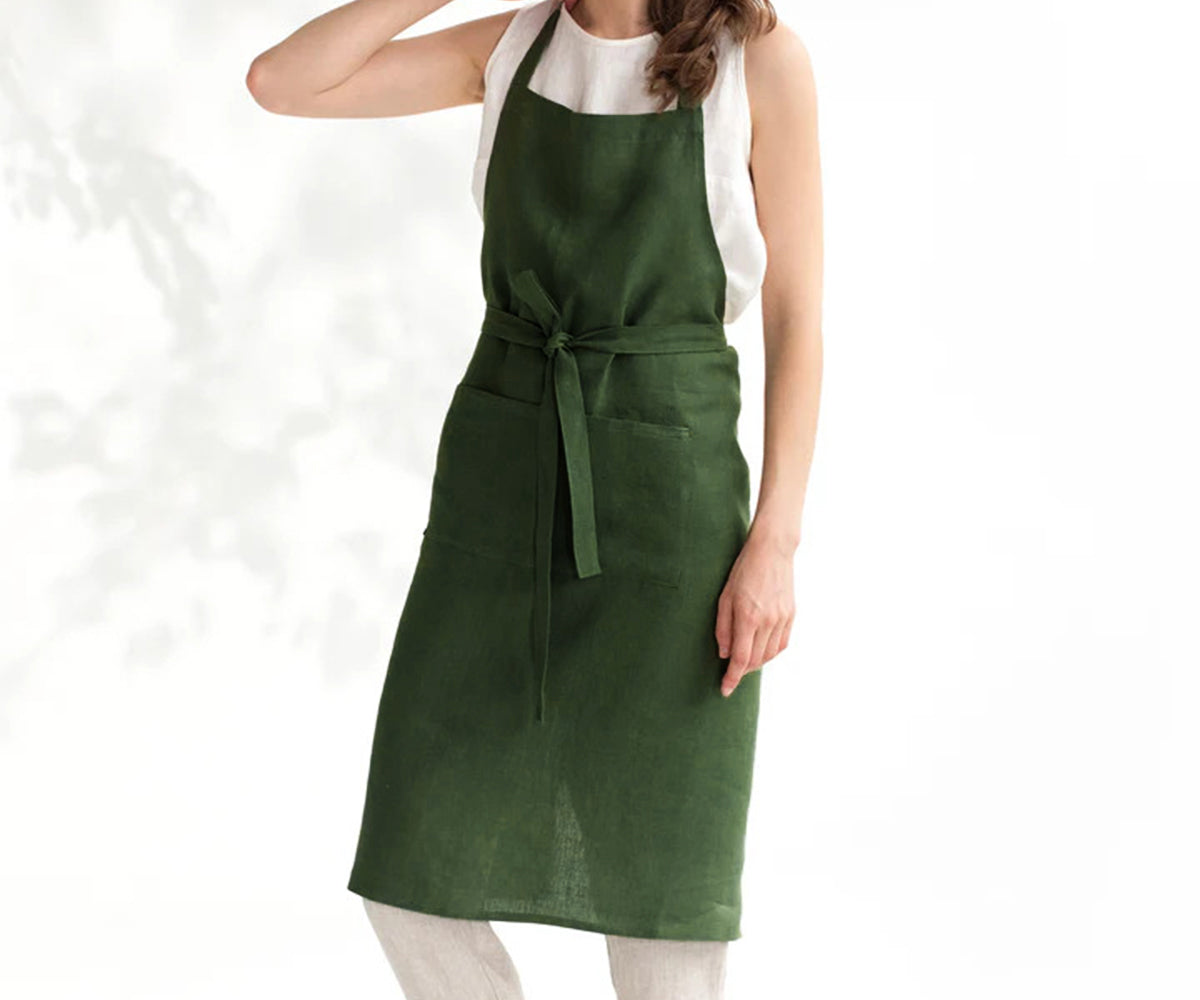 Emerald green aprons have large front pockets for holding tools, utensils, or essentials	