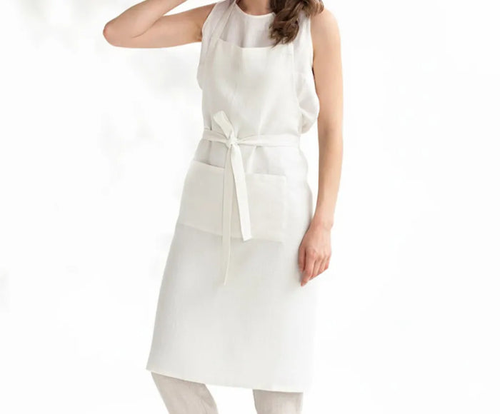 White linen blend cooking apron made from 50% linen and 50% cotton, lightweight and durable with adjustable ties, perfect for cooking, baking, grilling, or crafting, machine washable for everyday kitchen use.