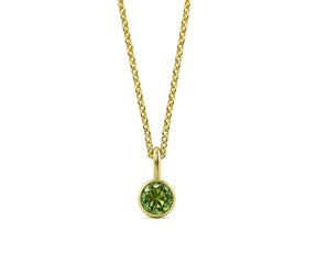 Minimalist women’s peridot necklace on white background