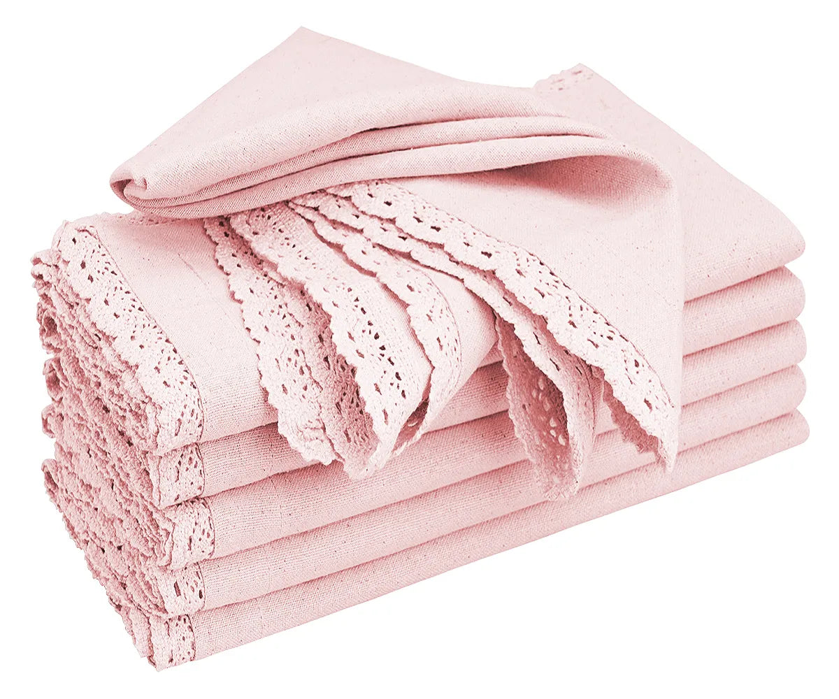 Baby pink cotton napkin with lace trim on a wedding table