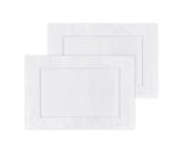 Two white bath mats with a subtle pattern on a white background