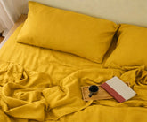 Soft mustard yellow linen fitted sheet with matching pillowcases, natural breathable linen bedding
