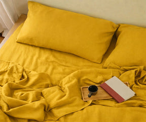 Soft mustard yellow linen fitted sheet with matching pillowcases, natural breathable linen bedding