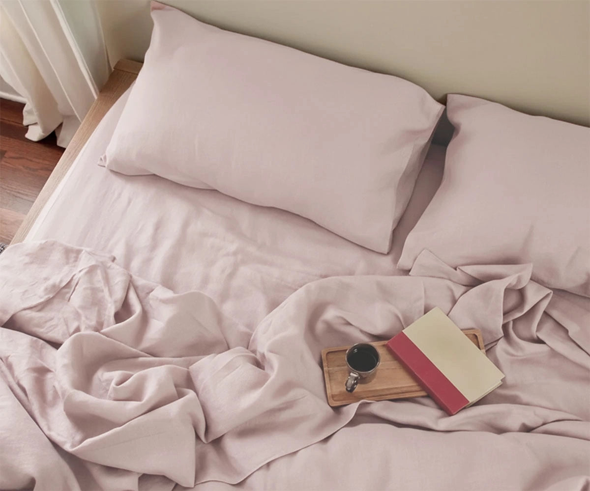 Soft pastel pink linen fitted sheet with matching pillowcases, breathable all-season linen bedding for modern bedroom décor