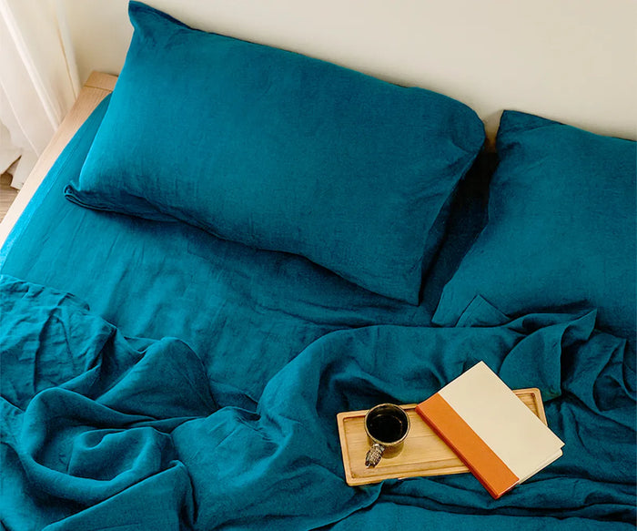 Luxurious teal linen bedding set with a smooth bedding sets teal, breathable texture, neatly layered on a bed to create a cozy, stylish, and modern bedroom look.