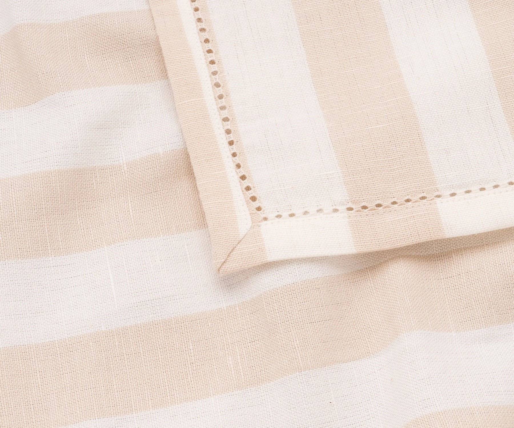 A set of beige cabana stripe cotton napkins, perfect for casual dining.
