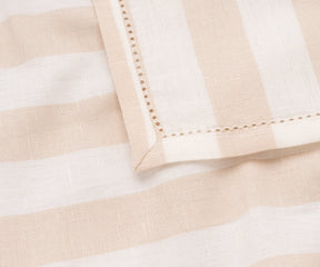 A set of beige cabana stripe cotton napkins, perfect for casual dining.
