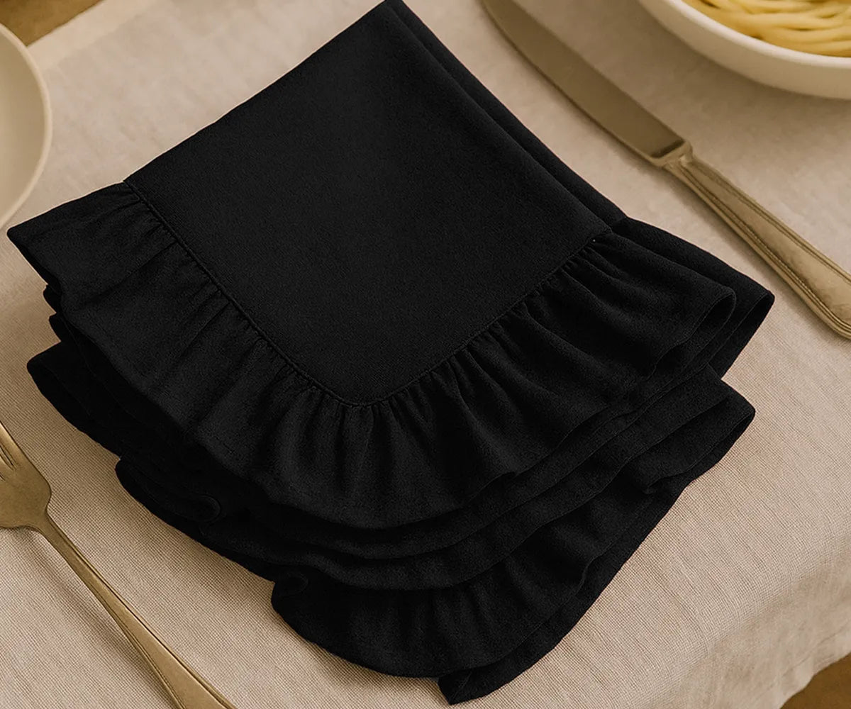Black cotton ruffle dinner napkins with soft frill edges, reusable and durable cloth napkins for weddings, parties, family dinners, and elegant farmhouse table décor.