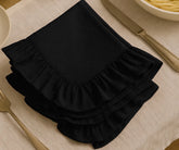 Black cotton ruffle dinner napkins with soft frill edges, reusable and durable cloth napkins for weddings, parties, family dinners, and elegant farmhouse table décor.