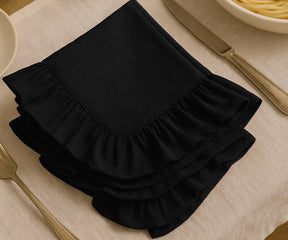 Black cotton ruffle dinner napkins with soft frill edges, reusable and durable cloth napkins for weddings, parties, family dinners, and elegant farmhouse table décor.