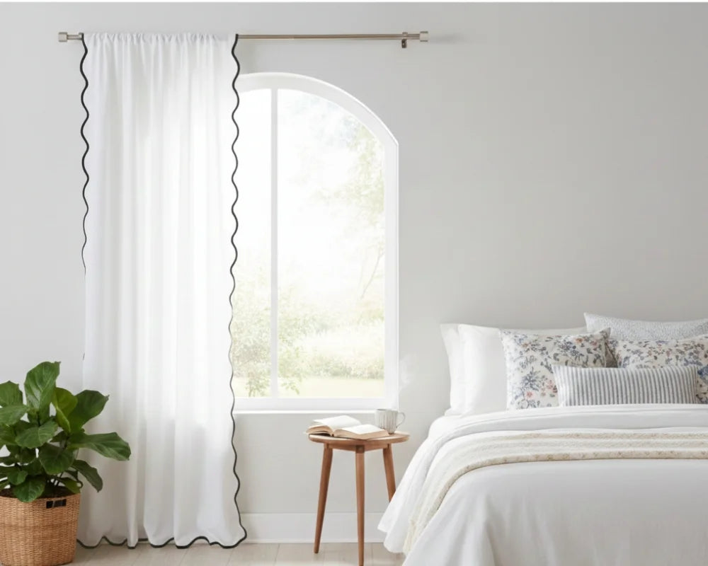 White curtain with Black wavy side trim in a bedroom setting