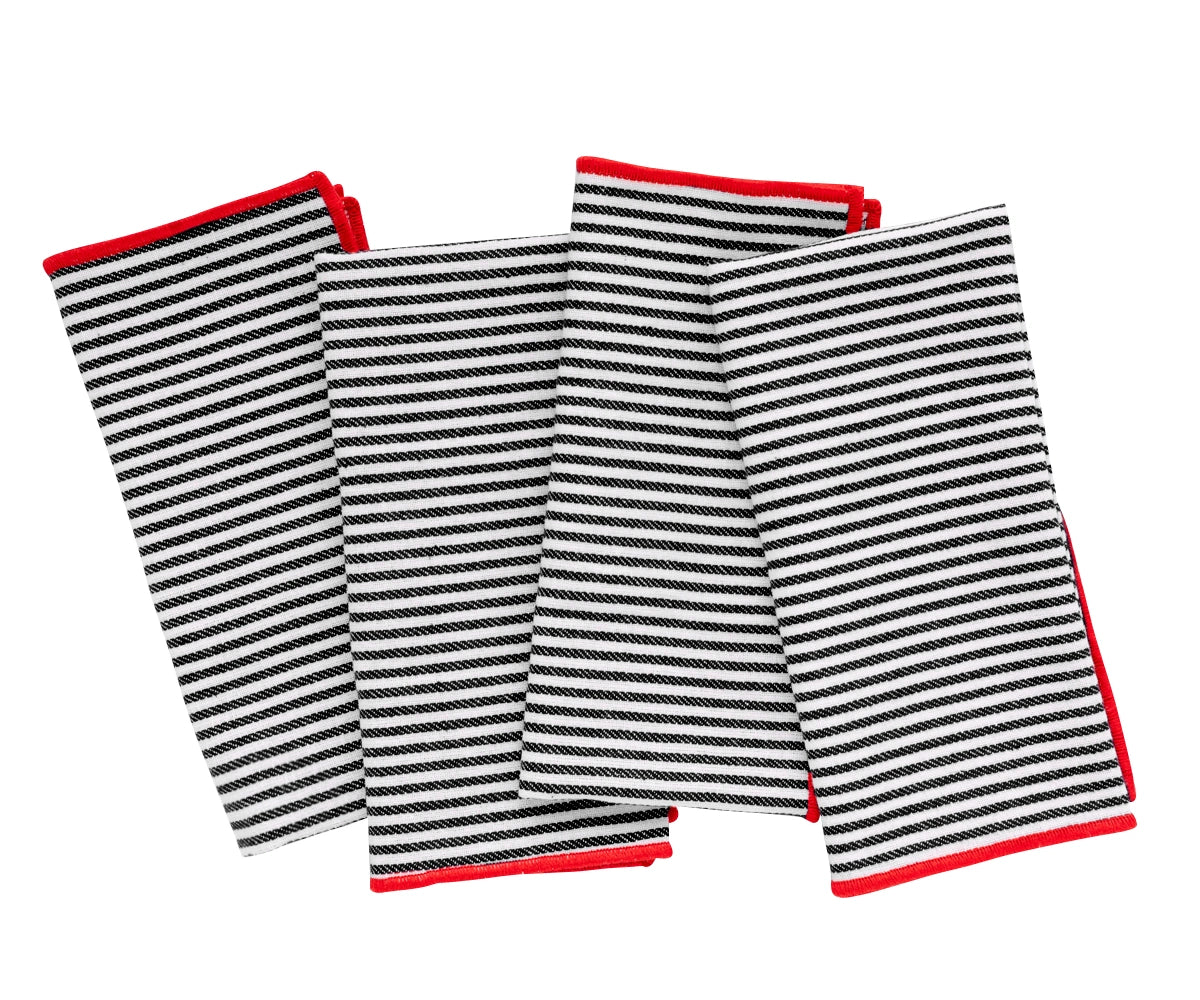 Black and red striped cotton dinner napkin set neatly folded on a dining table.