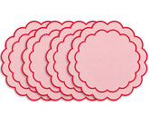 Round cotton placemat featuring a delicate scalloped edge and embroidered detailing for an elegant dining table setting
