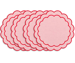 Round cotton placemat featuring a delicate scalloped edge and embroidered detailing for an elegant dining table setting