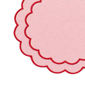Elegant cotton round placemats featuring a scalloped edge and detailed embroidered design