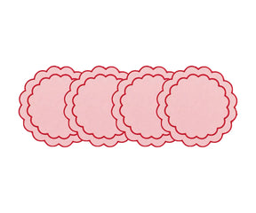 Round cotton placemats with scalloped edges and embroidered detailing for elegant dining table décor