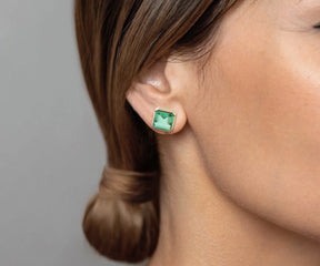 Gold stud earrings with 10mm Asscher-cut emerald green quartz stones, set in 18K gold-plated brass with secure push-back closure.