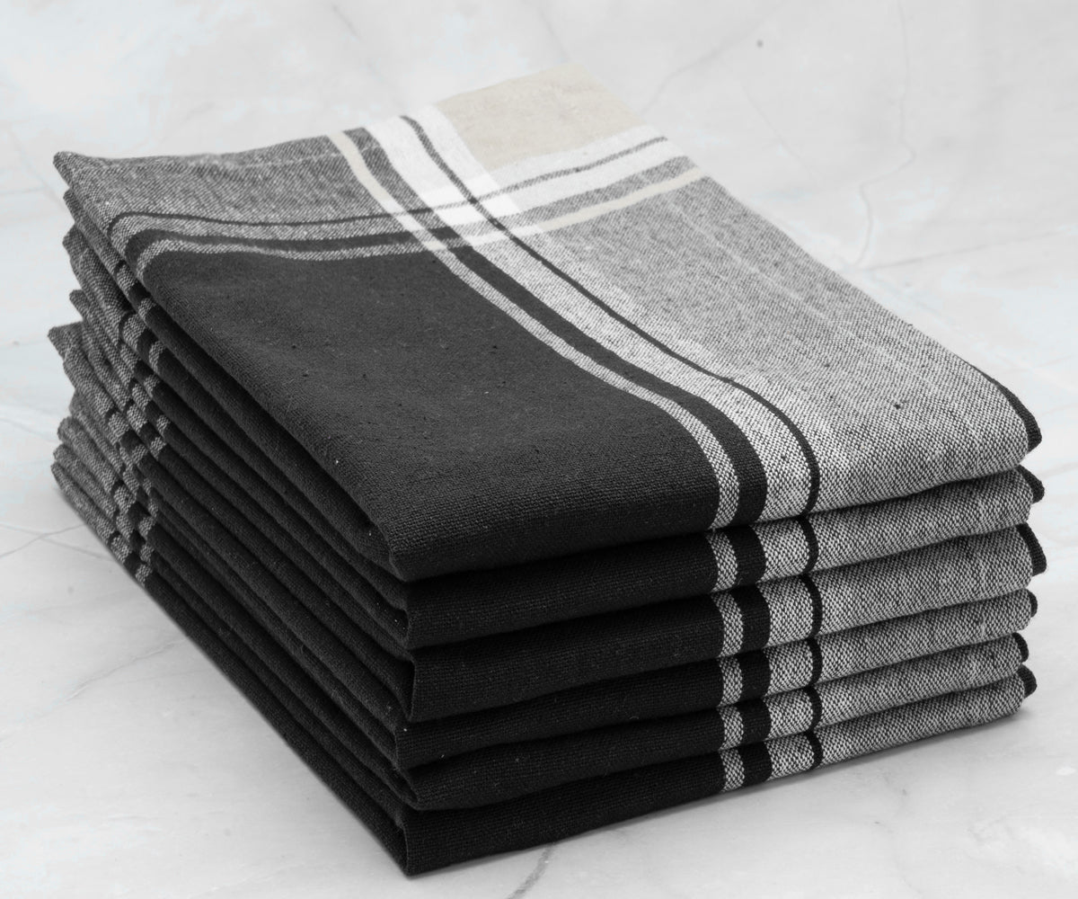 Stack of six blue and white striped restaurant napkins with a black and white filter