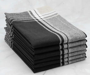 Black and white stripe napkins - Black and white striped napkins placed on a monochrome table setting.
