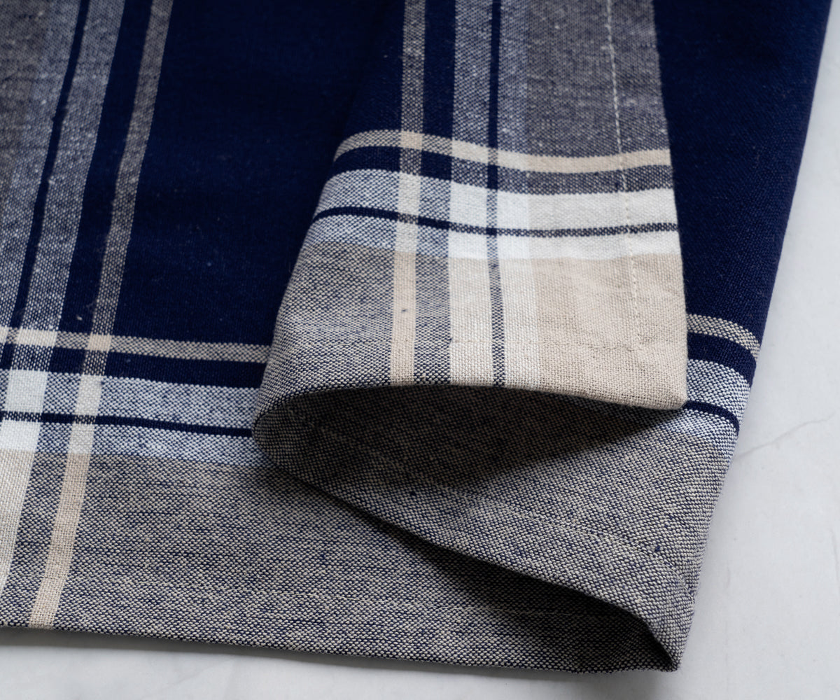 Blue and white checkered bistro napkin presented on a marble countertop