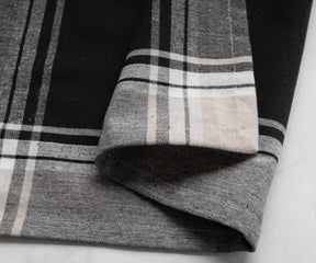 Black and white plaid bistro napkin displayed on a marble surface