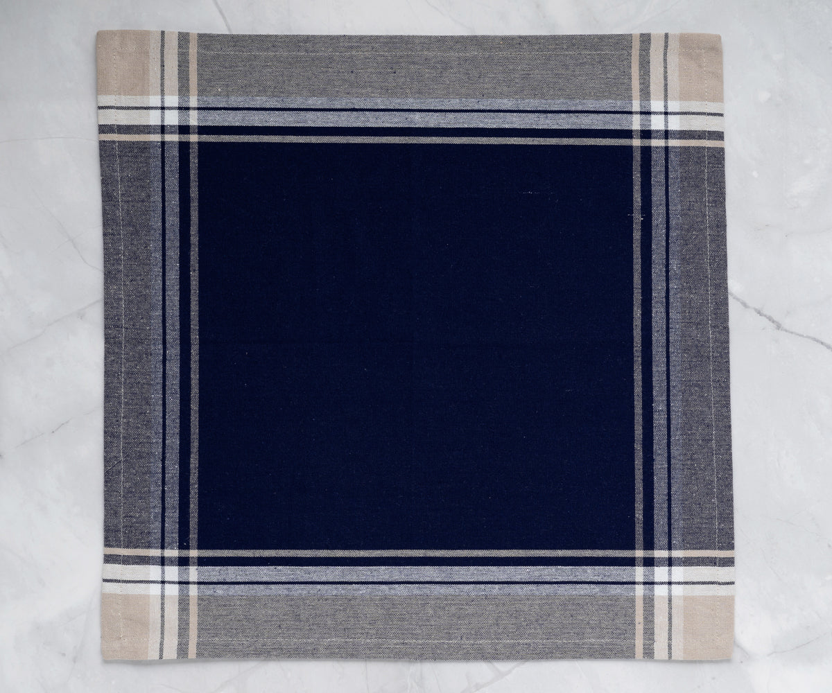 Close-up view of a restaurant napkin with navy blue and white checkered pattern