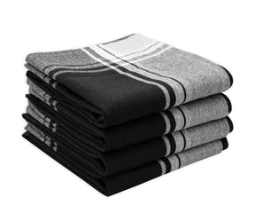 Kitchen dish towels draped over a wooden cutting board in a rustic kitchen setting.