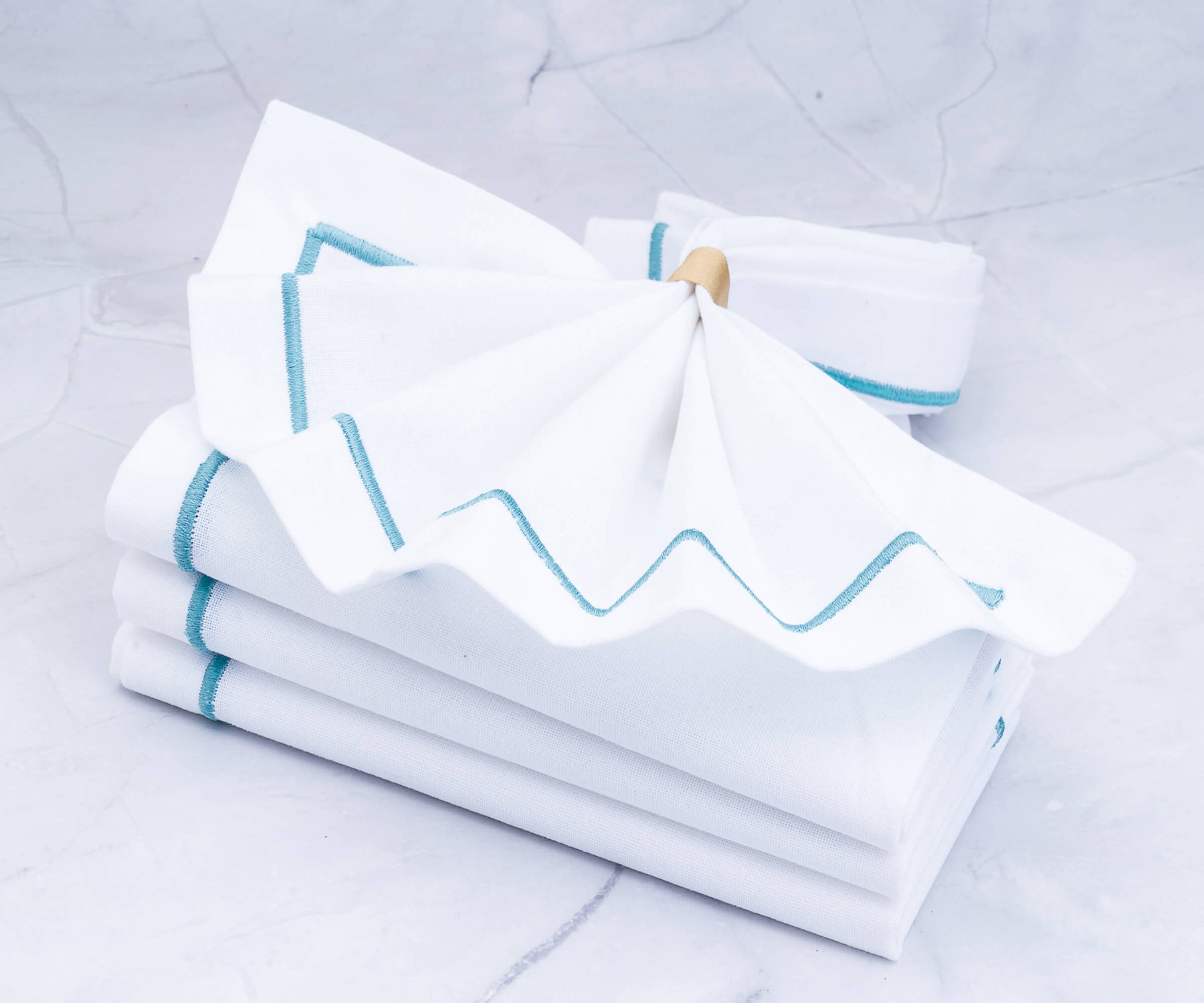 Pile of white dinner napkins with blue stripes