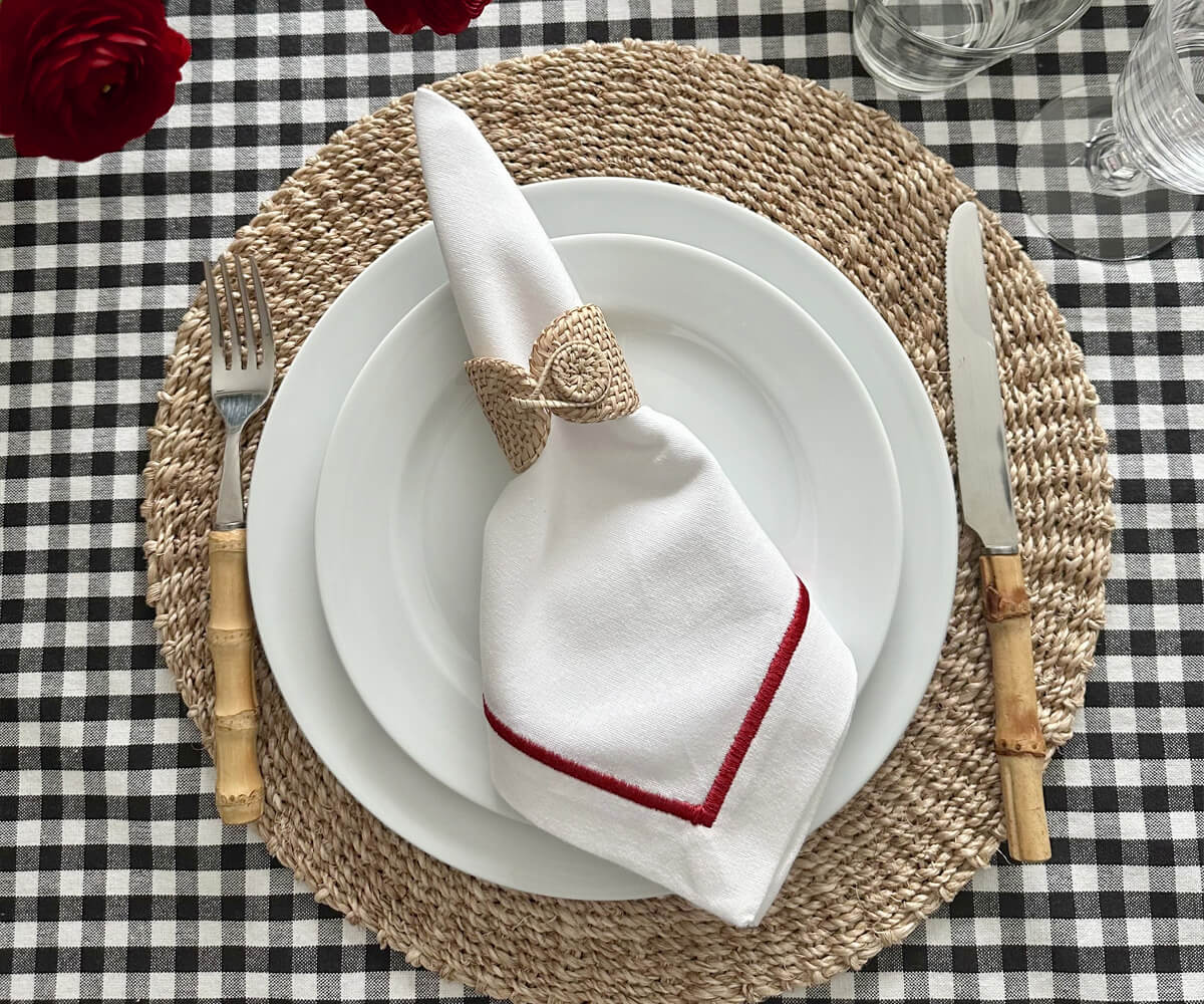 Table setting featuring a white plate and white dinner napkin