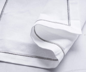 White linen napkin with silver trim detail