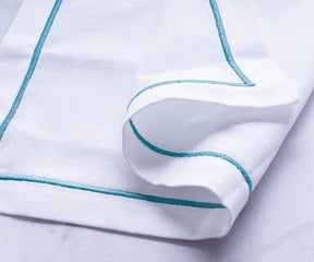 Blue cloth napkins arranged neatly, adding a pop of color to the table.