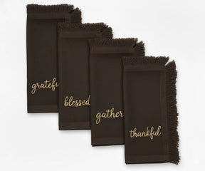 Elegant brown embroidered napkins with gold lettering and fringed edges – perfect for Thanksgiving dining
