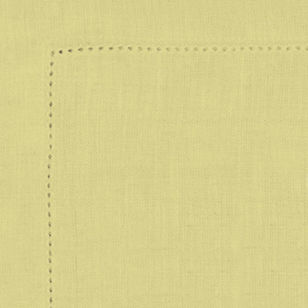 Close-up of a light yellow fabric with a seam on a matching background
