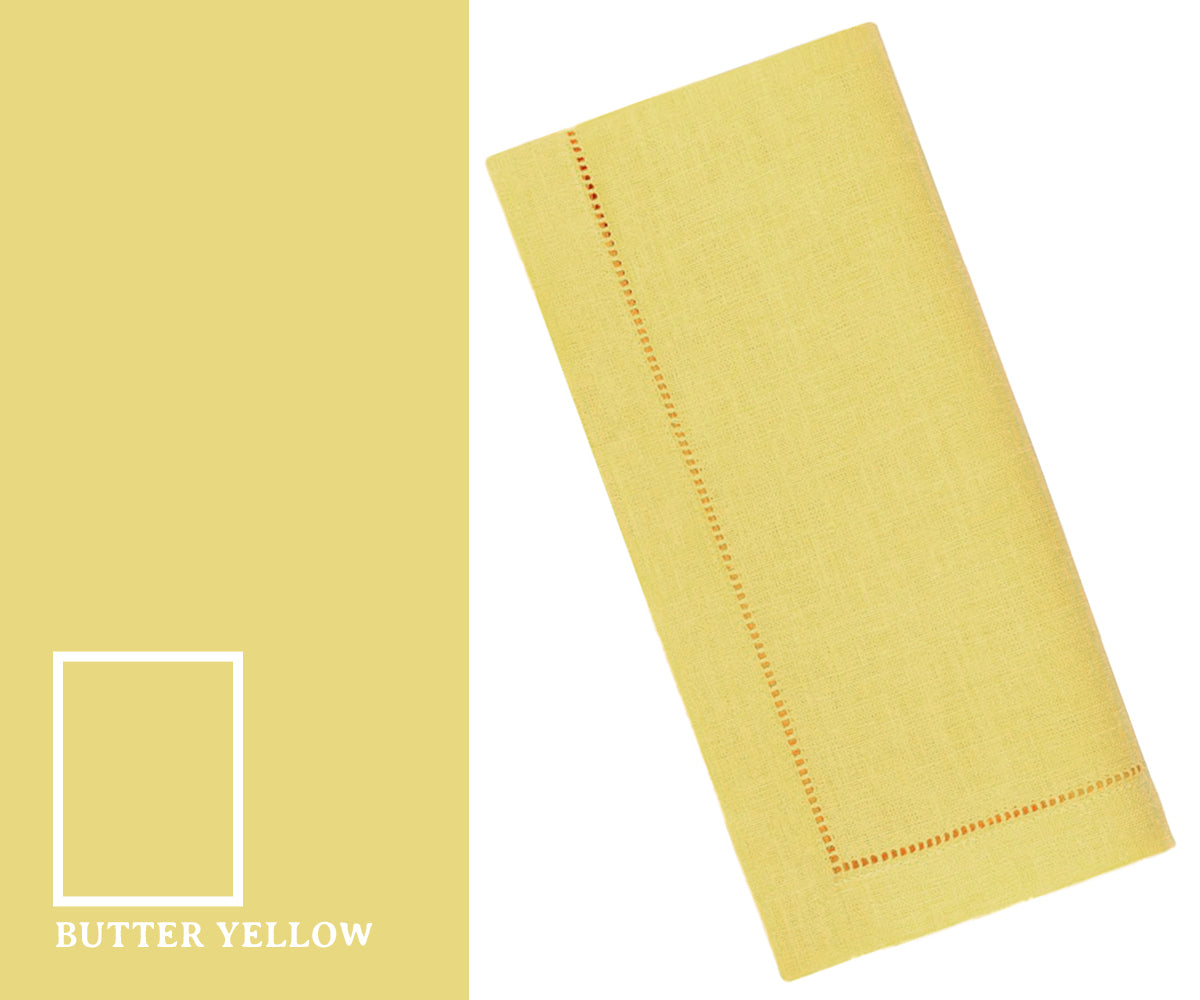 Butter yellow napkins neatly folded for an elegant dining table setting, perfect for everyday meals, parties, or special occasions.