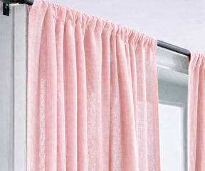 Soft light pink linen curtains filtering natural sunlight, perfect for airy living rooms, minimal interior