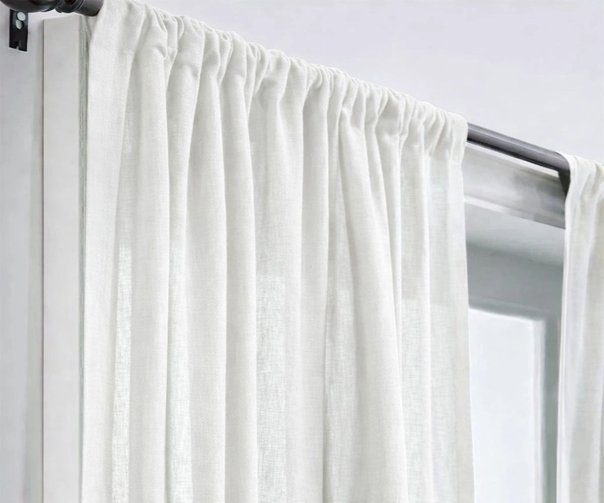 Classic white linen curtains designed to enhance natural light, creating a fresh, open living room feel with breathable, high-quality linen fabric.