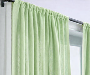 Matcha green linen curtains creating a soothing, nature-inspired living room ambiance, made from eco-friendly linen with soft light filtering.