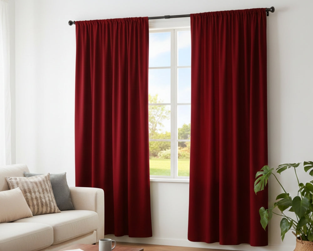 Solid red curtains hanging in living room window