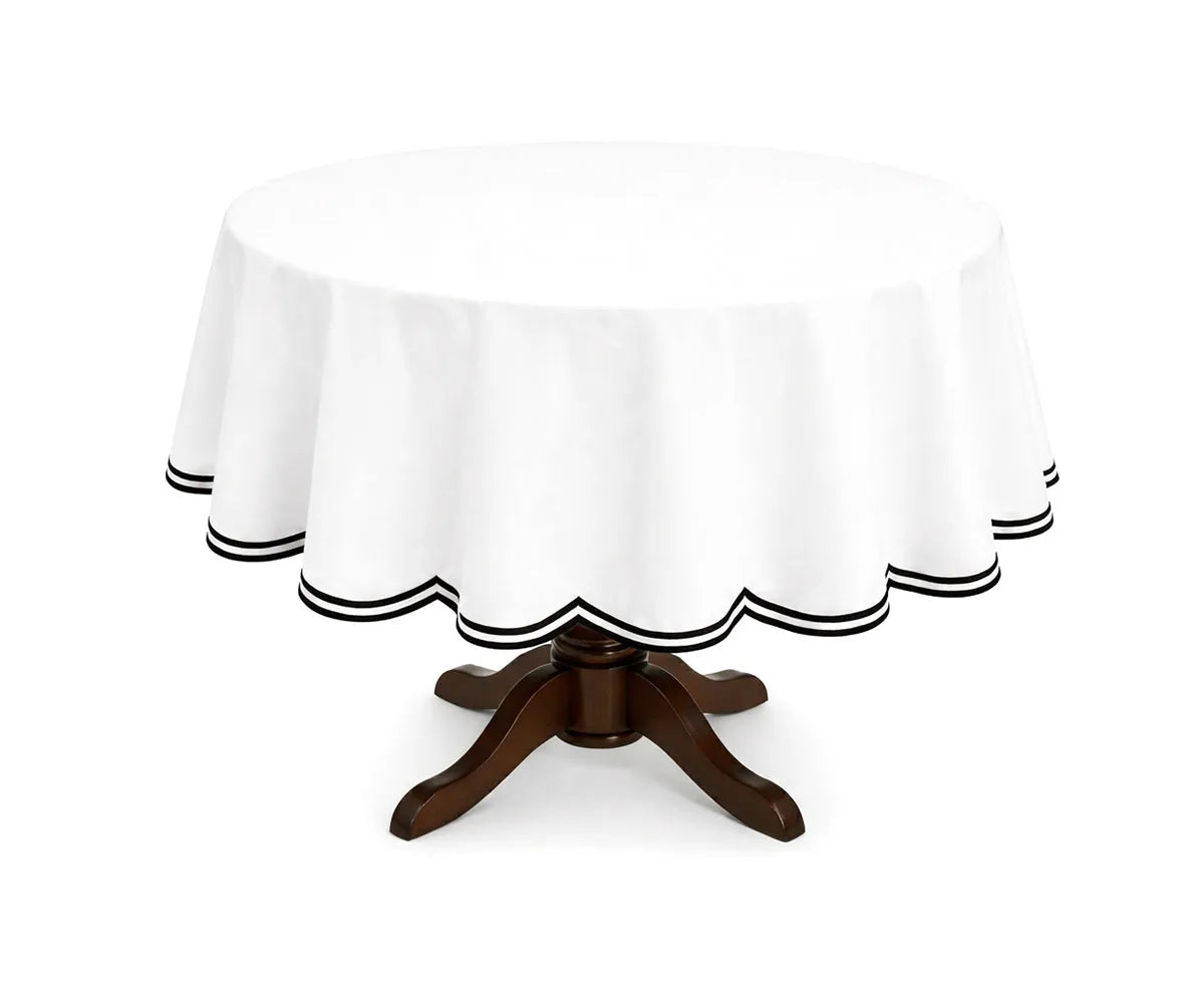 Black round cotton tablecloth with a double scalloped edge, crafted from 100% cotton for a smooth drape on round dining tables. The contrasting scalloped border adds a refined touch, making it suitable for everyday meals, formal dinners, and seasonal table settings.